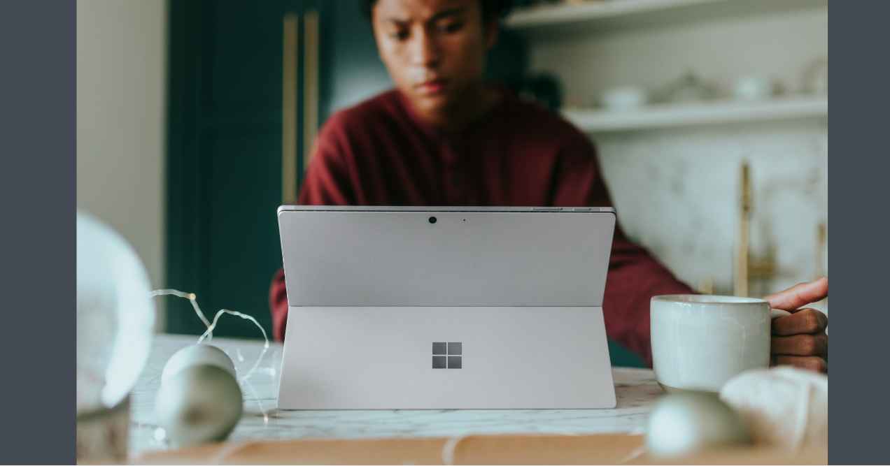 a girl is using microsoft surface